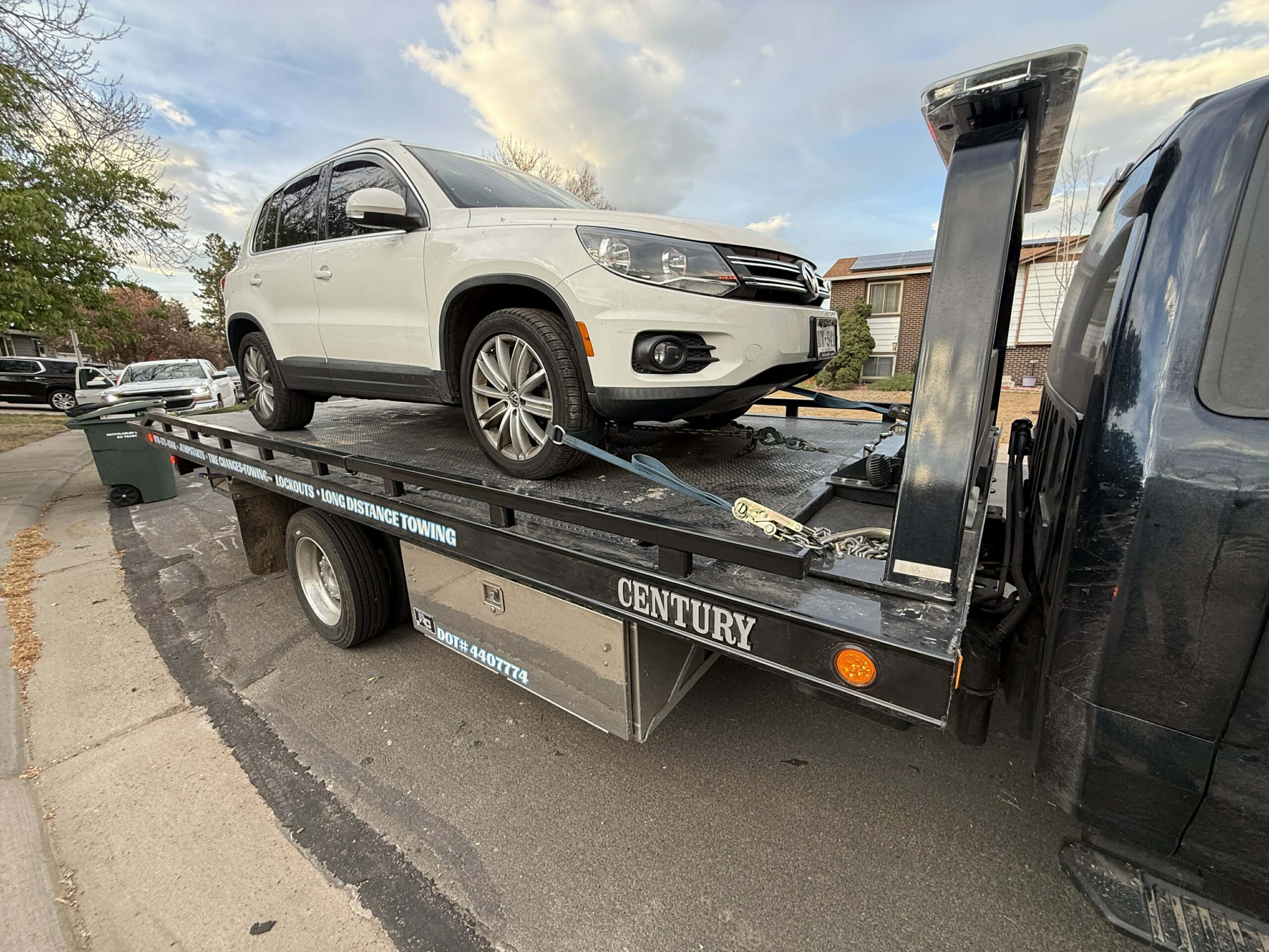 White SUV positioned on a flatbed for specialty vehicle transport