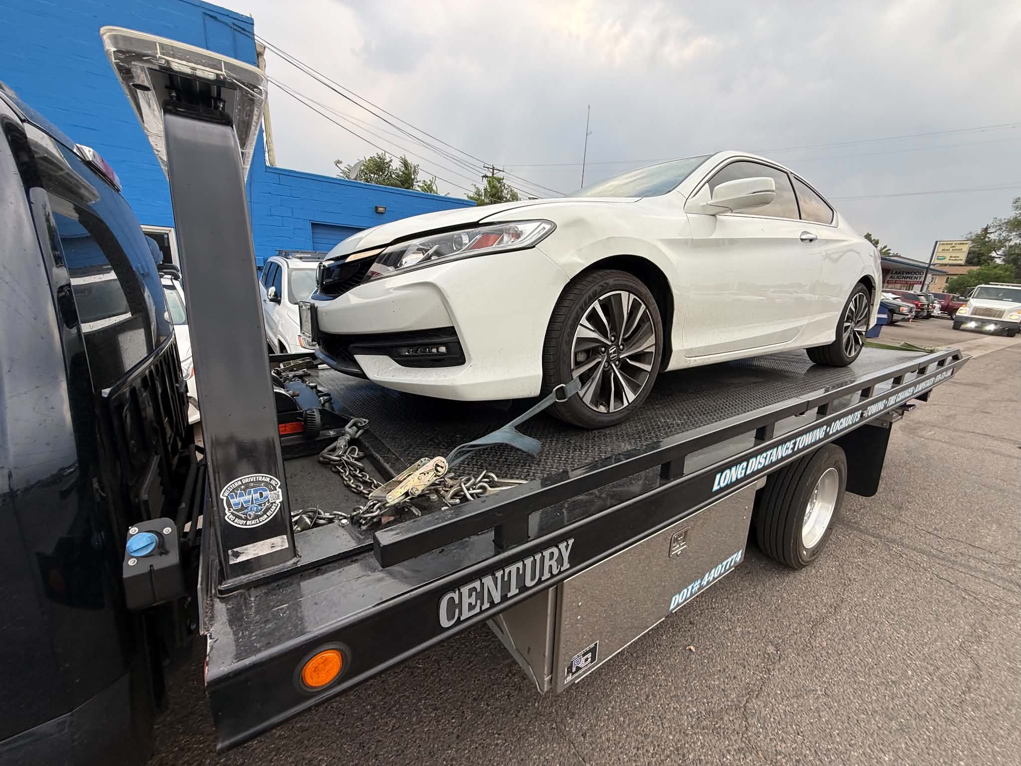 White sports car secured on a First Response Towing flatbed in the Daily Towing Jobs gallery