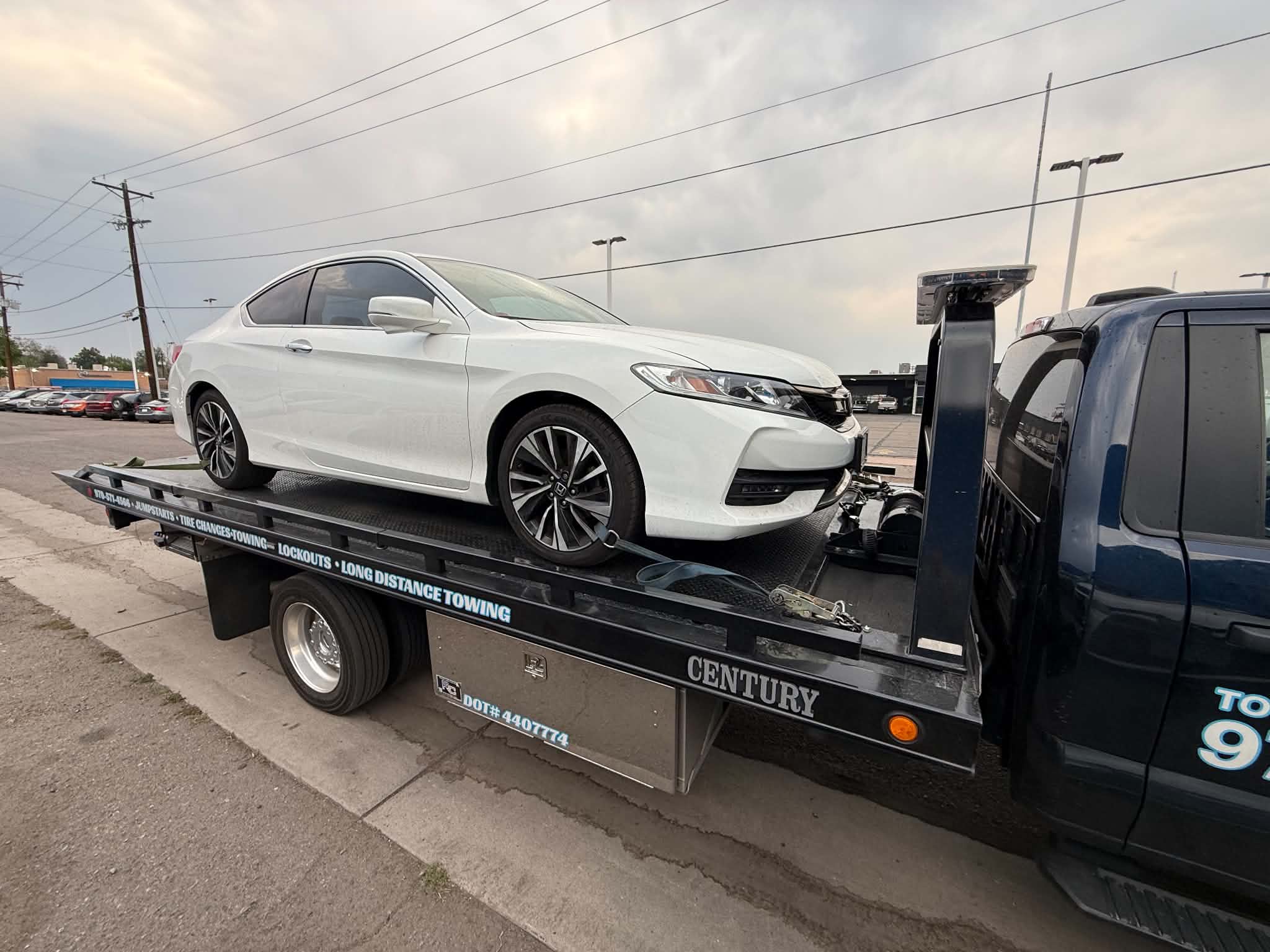 White coupe being loaded onto a First Response Towing flatbed for the Daily Towing Jobs gallery